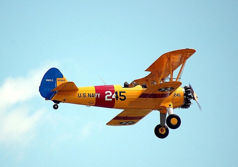 A Flying Aircraft with a Yellow and Red Frame and Blue Tip